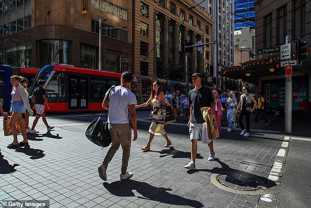 Super balances have had the best year since 2021 as Labor plots how to increase taxes on retirement savings (pictured at pedestrians in Sydney's city centre)