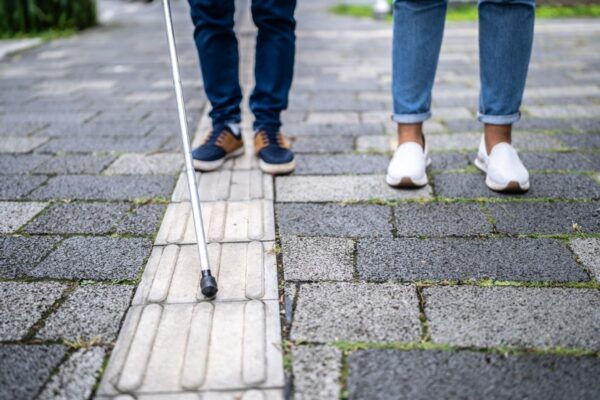 Visually impaired person walking in the street